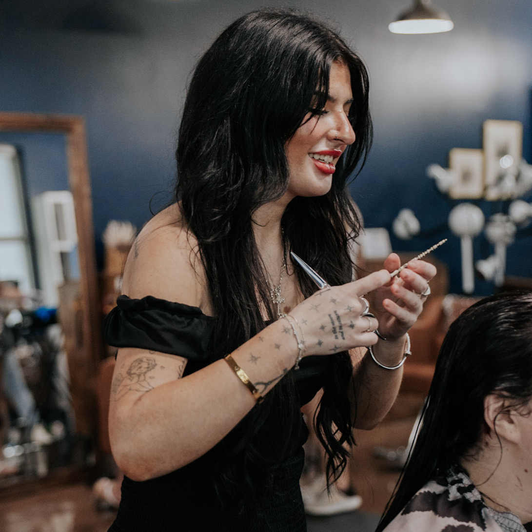 Pearls and Whiskey stylist caring for a salon guest
