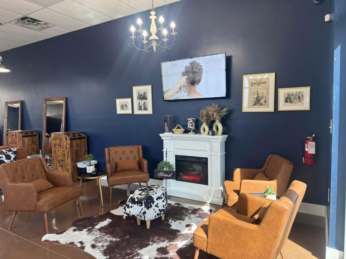 Western-inspired lounge and fireplace inside Pearls & Whiskey salon in Goose Creek, South Carolina