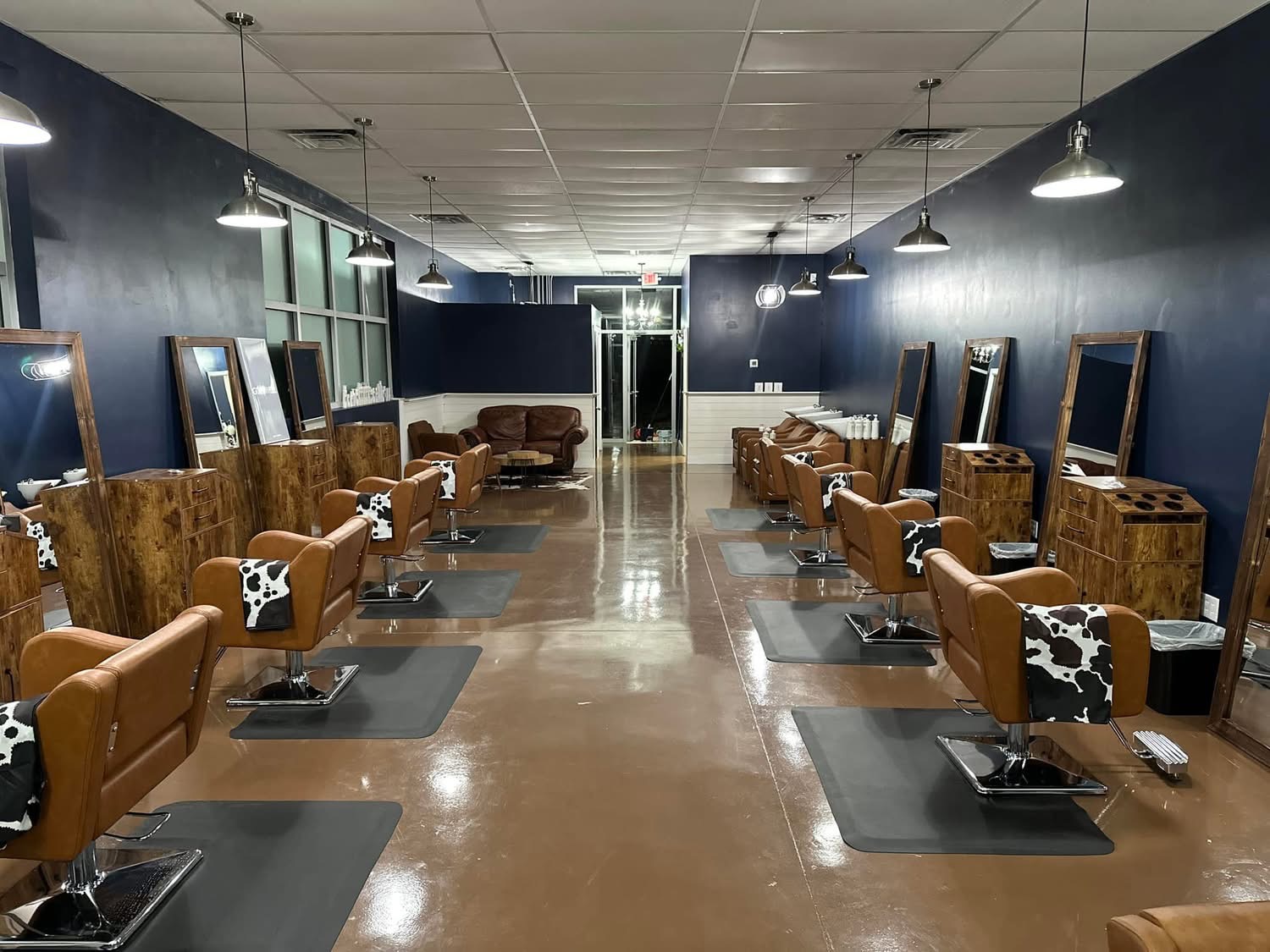 Warm leather styling chairs and spacious salon stations at Pearls & Whiskey in Goose Creek