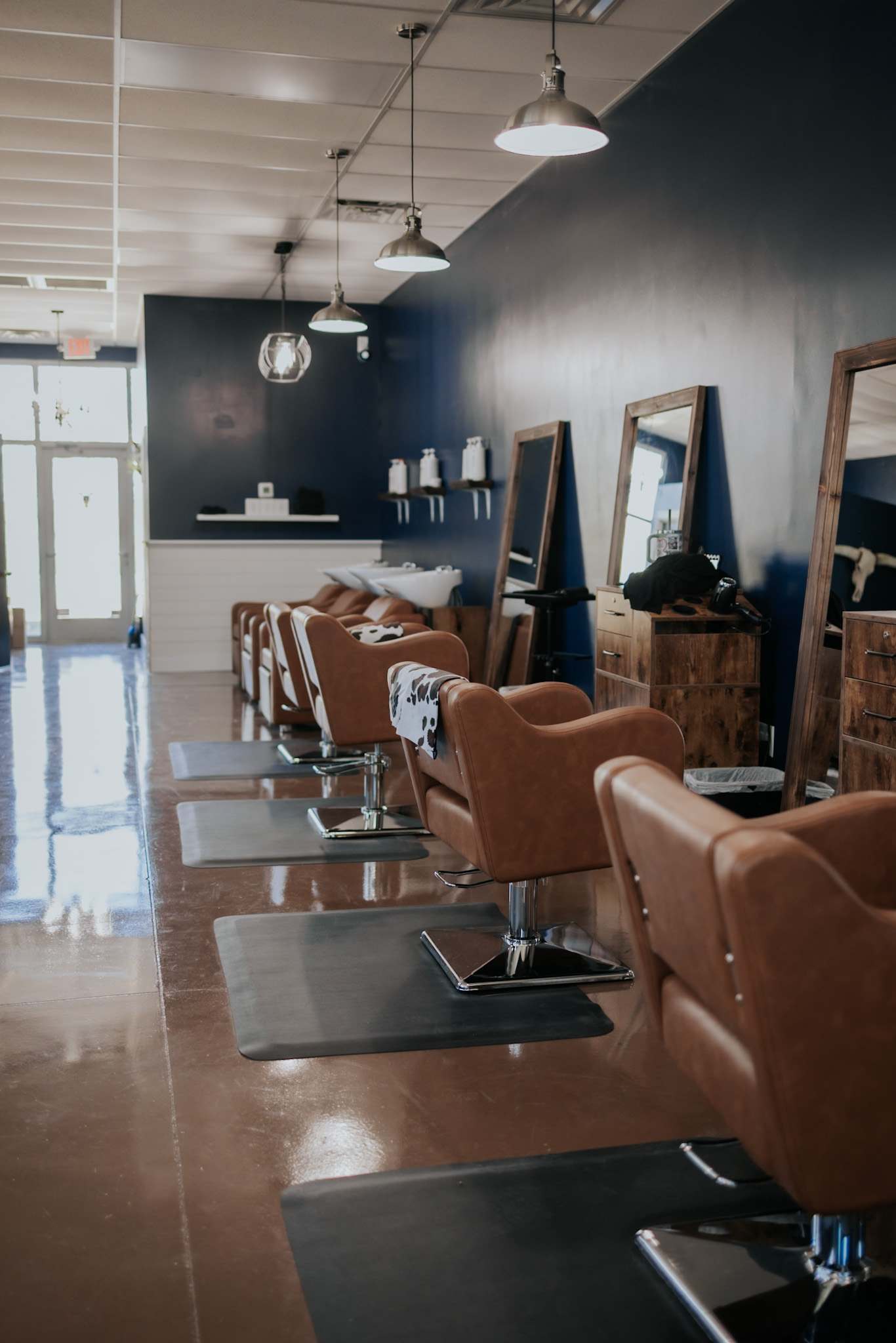 Modern Western salon interior with styling stations at Pearls & Whiskey in Goose Creek