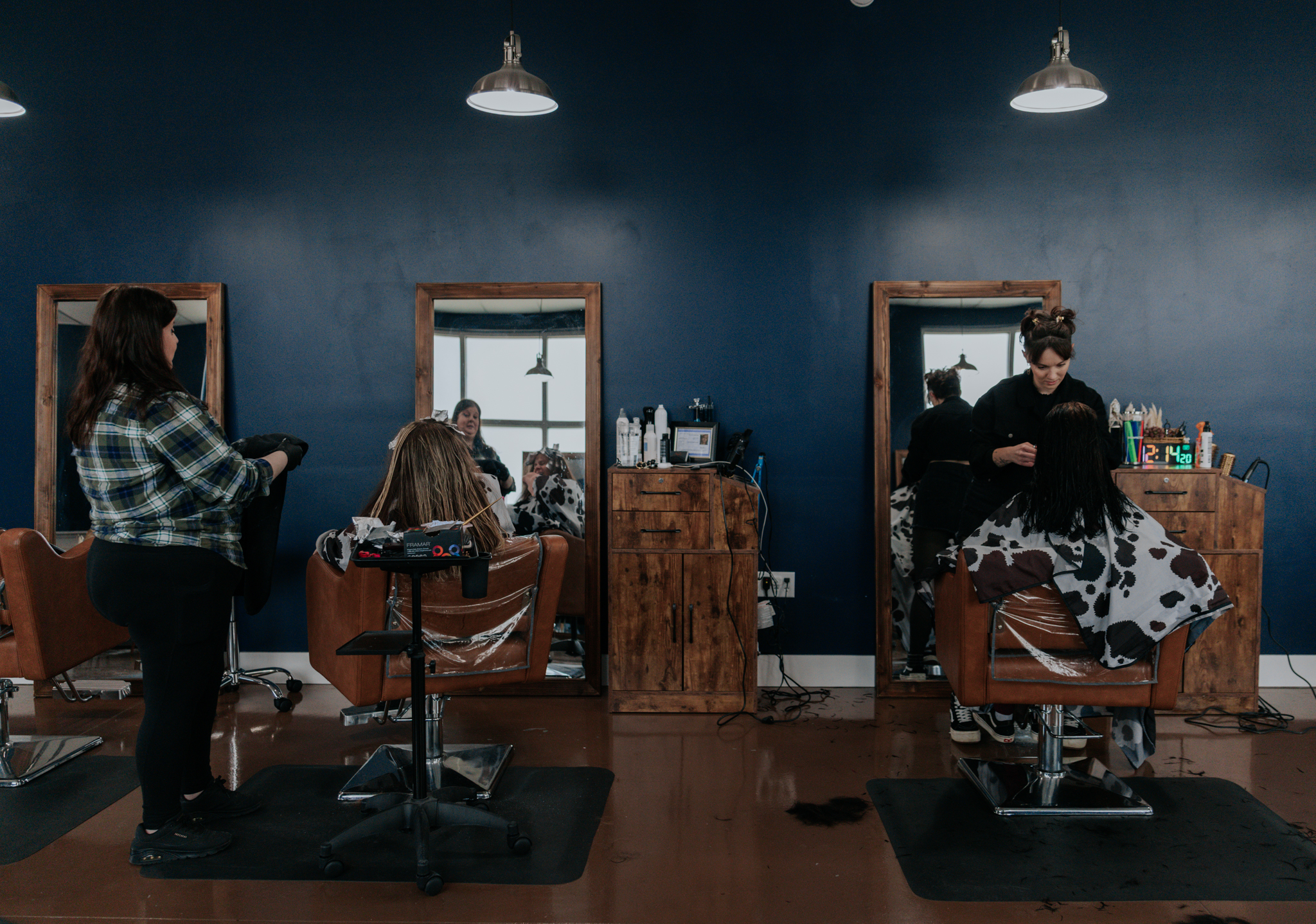 Stylists serving guests inside Pearls and Whiskey in Goose Creek