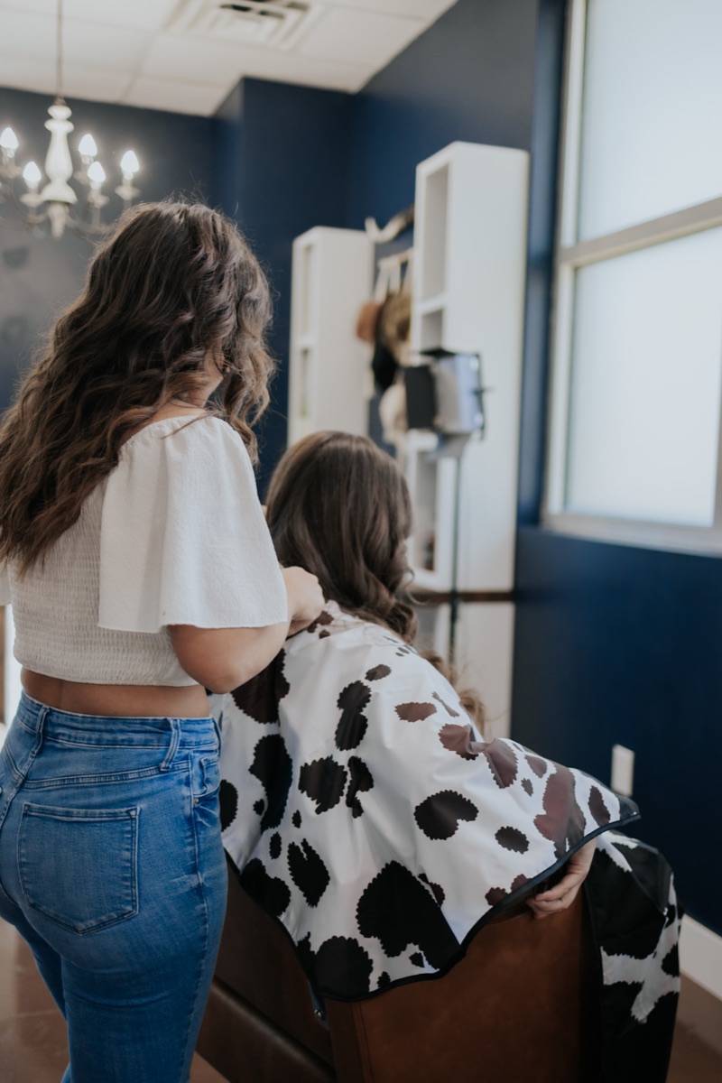Pearls & Whiskey stylist creating a personalized haircut for a guest in Goose Creek, South Carolina