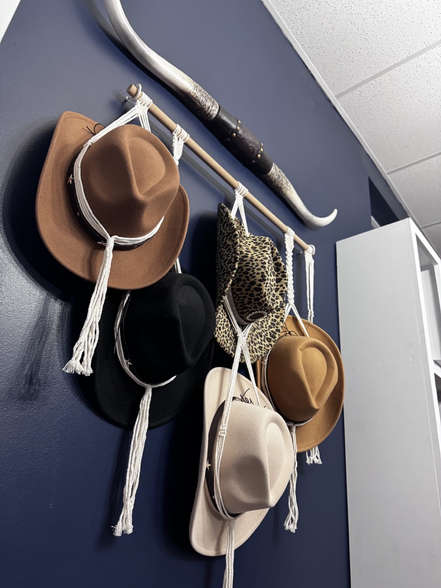 Western hats and longhorn wall décor reflecting the spirit of Pearls & Whiskey salon
